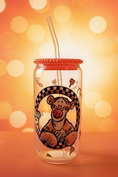 Tigger glass can cup with straw and orange sunny background